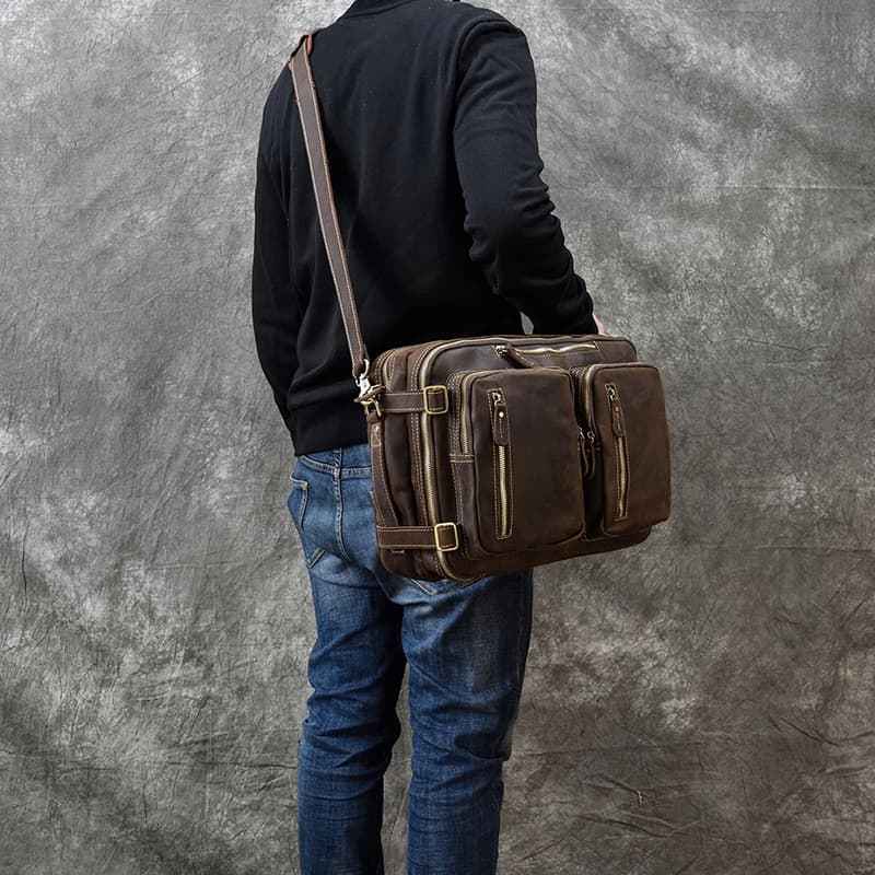 Dark brown leather crossbody backpack briefcase worn with multiple exterior pockets
