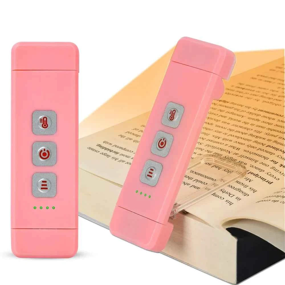 Rechargeable bookmark reading lamp in pink with three control buttons and green indicator lights.