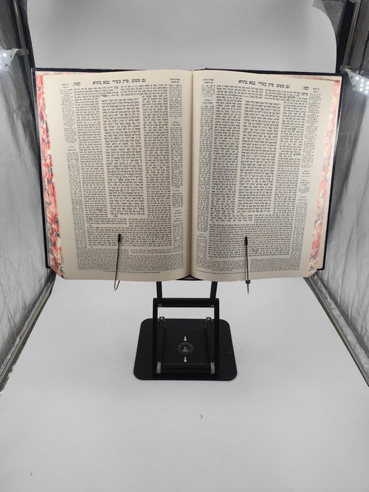 The Stander holding a full-size Oz V'Hadar Chasan Shas Gemara, Bava Batra, open on its platform