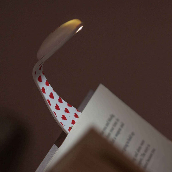 White bookmark light with red heart pattern, slim curved clip