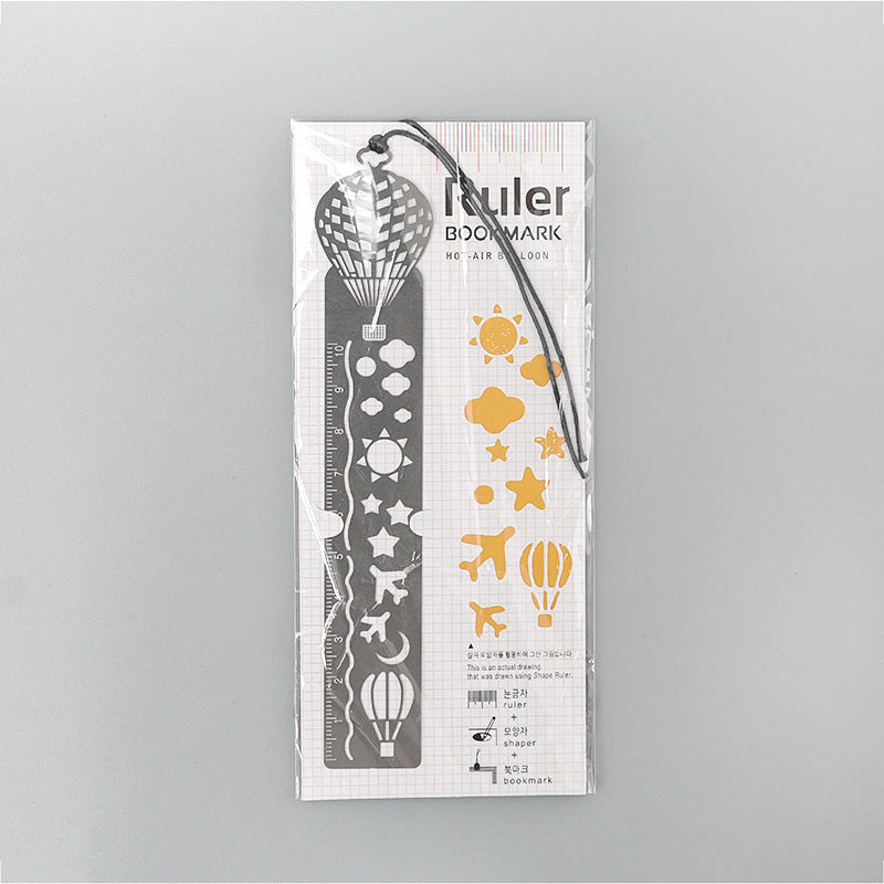 Packaged metal bookmark with hot-air-balloon cutouts, white design and black cord.