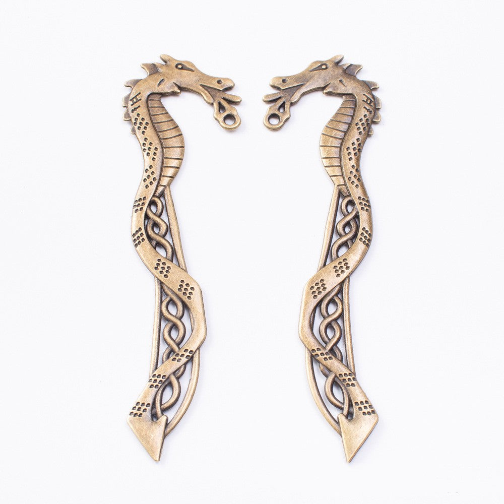 Two bronze vintage seahorse bookmark charms with ornate etched patterns