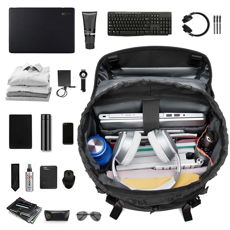 Black backpack laid open with multiple interior pockets and accessories