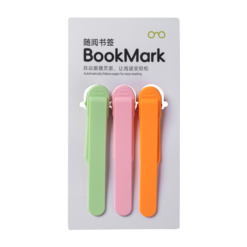 Silicone bookmark holder clips on a card: green, pink, and orange