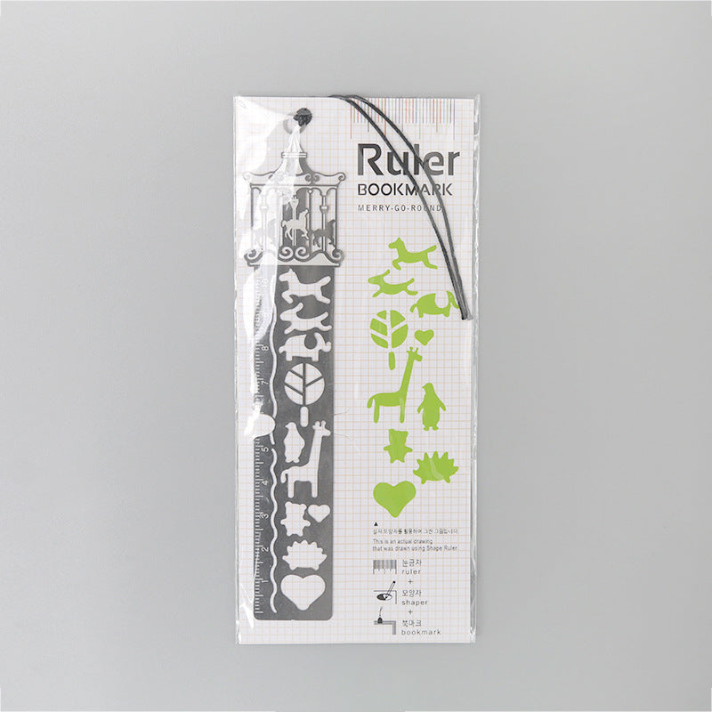 Packaged metal bookmark with merry-go-round cutouts, white design and black cord.