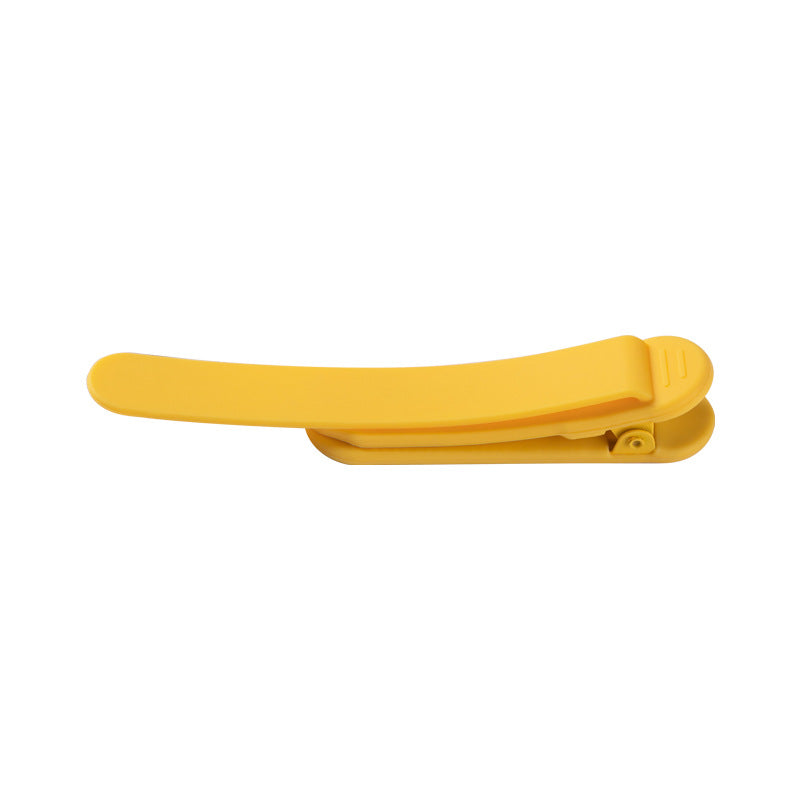 Silicone bookmark holder clip in yellow, open claw design
