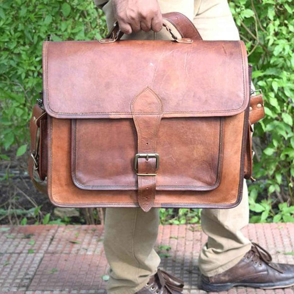Brown leather messenger bag with front flap and central buckle clasp