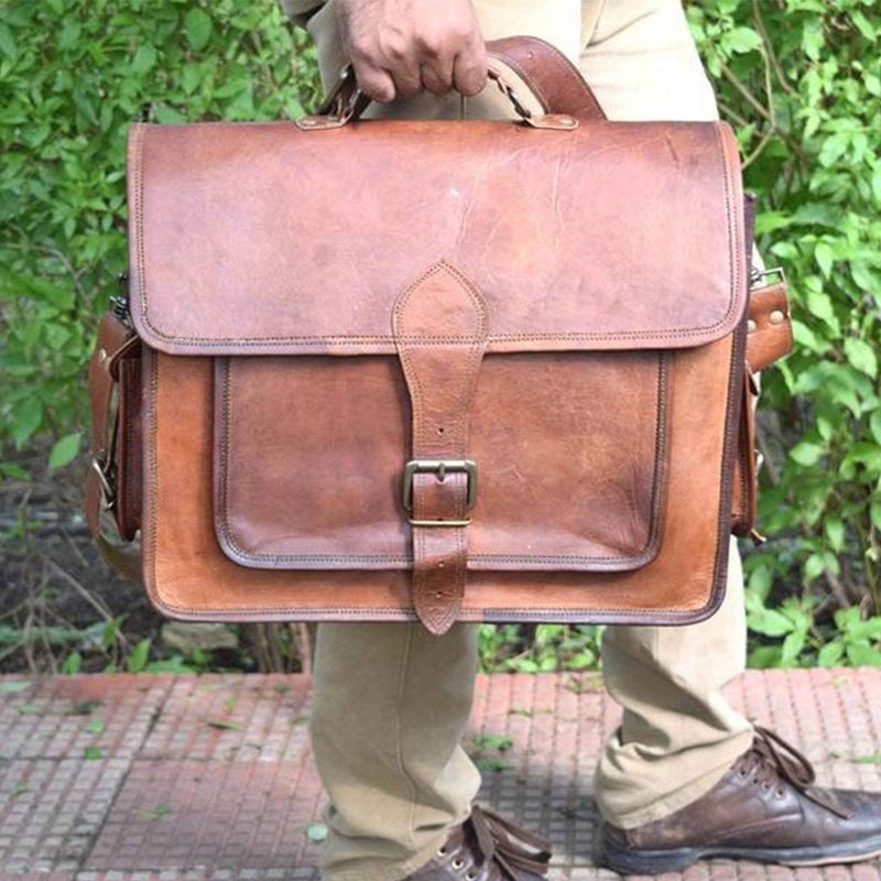 Brown leather messenger bag with front flap and central buckle clasp