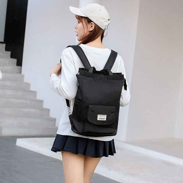 Black waterproof laptop backpack with padded back panel and dual shoulder straps