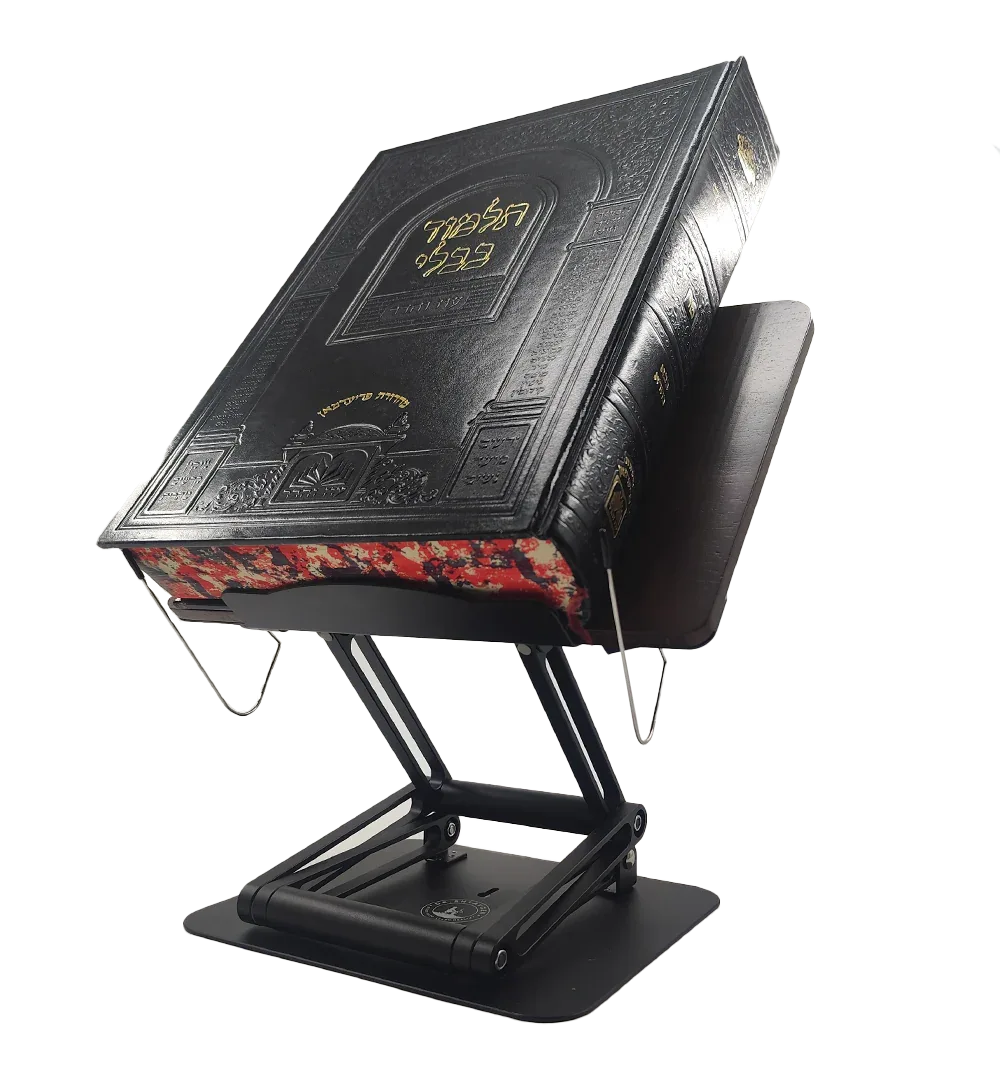 Heavy sefer supported securely on adjustable ergonomic book stand for comfortable Torah reading at eye level